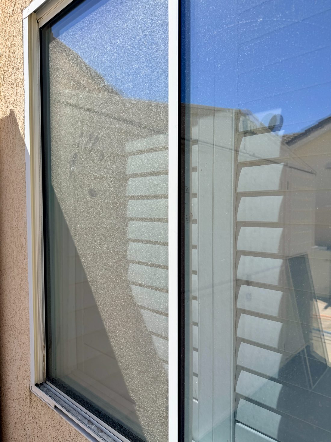Window glass before cleaning, dulled by dust and hard-water film